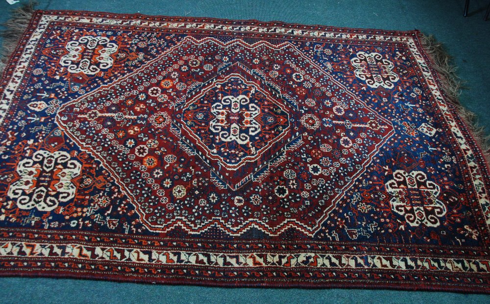 SHIRAZ PERSIAN LARGE RUG, with large and concentric centre medallion with a mainly crimson ground,