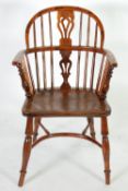 NINETEENTH CENTURY YEW, ELM AND FRUITWOOD LOW BACK WINDSOR ARMCHAIR, the spindled back with pierced
