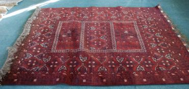 TURKOMAN CARPET with triple large tile pattern centre with a broad principal border and multiple