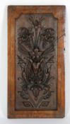 NINETEENTH CENTURY CARVED OAK PANEL, oblong, the centre carved in high relief with stylised floral