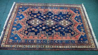 SHIRAZ PERSIAN RUG, with white and cross patterned triple, diamond shaped, chain medallions on a