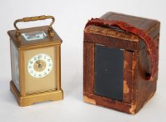 EARLY 20TH CENTURY BRASS GONG STRIKING CARRIAGE CLOCK, the gilt mask housing a 1 3/4"" Arabic dial