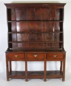 EIGHTEENTH CENTURY OAK DRESSER, the plate rack with moulded cornice above three shelves and plank