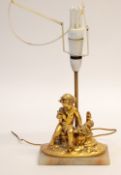 GILT METAL FIGURAL TABLE LAMP, cast as a putto seated beside a flower vase, on a veined onyx base,