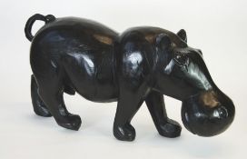 MODERN EBONISED CARVED HARDWOOD MODEL OF A HIPPOPOTAMUS, 15 1/2"" (39.4cm) high, 31"" (78.8cm) long