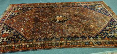 QASHQAI SEMI ANTIQUE PERSIAN CARPET, with small hexagonal midnight blue centre medallion on a brick