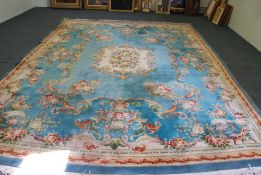 A WASHED CHINESE CARPET OF AUBUSSON DESIGN with off white  and floral centre medallion on a pale