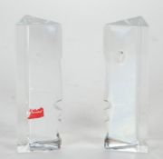 PAIR OF BACCARAT RRIGOT CUT GLASS ORNAMENTS, with stylised profiled faced, triangular form, 5 1/4""