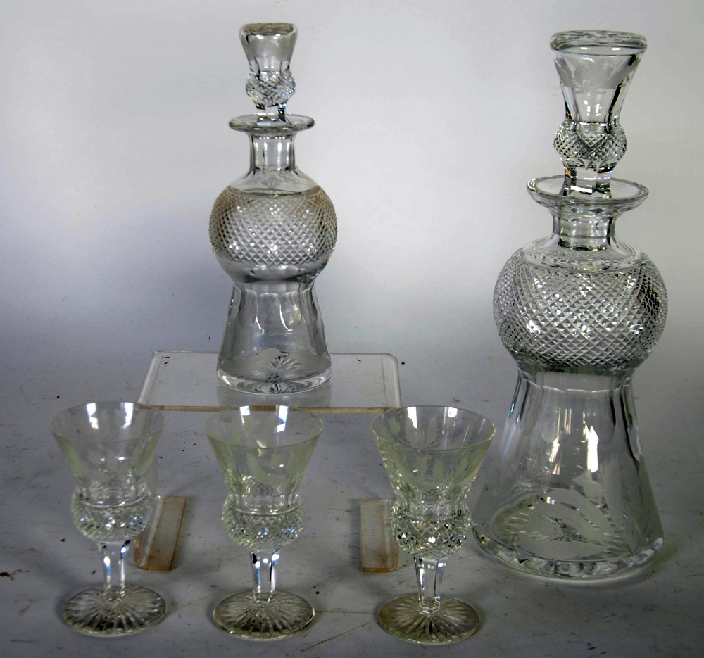 GRADUATED PAIR OF EDINBURGH CUT AND ETCHED GLASS THISTLE SHAPED DECANTERS AND STOPPERS, 12"" and 8