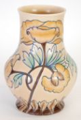 ROYAL CAULDON TUBE LINED POTTERY VASE of footed balusater form, printed in washed tones of green,