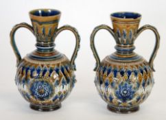 PAIR OF DOULTON LAMBETH MOULDED POTTERY TWO HANDLED VASES, each of footed baluster form with scroll