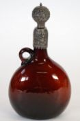 RUBY GLASS AND INDIAN SILVER METAL MOUNTED WINE JUG, and stopper, flattened form with loop handle,