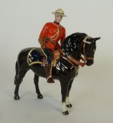 A BESWICK CHINA MODEL OF A CANADIAN MOUNTIE ON HORSEBACK, 8 ½"" (21.5cm) high, printed mark  (af)