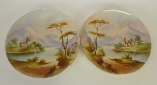 A PAIR  OF VICTORIAN STAFFORDSHIRE POTTERY WALL PLAQUES, each enamelled autour with lakeland