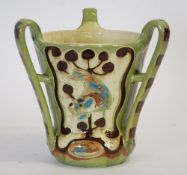 C.H. BRANNAM, THREE HANDLED SLIP TRAILED POTTERY VASE, of flared form with closed fitting,