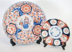 JAPANESE LATE MEIJI PERIOD IMARI PORCELAIN WALL PLAQUE, circular scalloped form, painted with