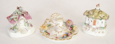 NINETEENTH CENTURY STAFFORDSHIRE FLORAL ENCRUSTED PORCELAIN CHAMBERSTICK, in the rococo style, of