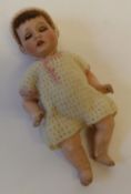 AN EARLY TWENTIETH CENTURY SIMON AND HALBIG SMALL BISQUE HEADED DOLL, with sleeping blue eyes and