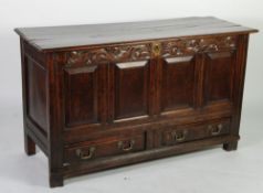 EARLY EIGHTEENTH CENTURY CARVED OAK MULE CHEST, the three plank top with moulded edge, above a