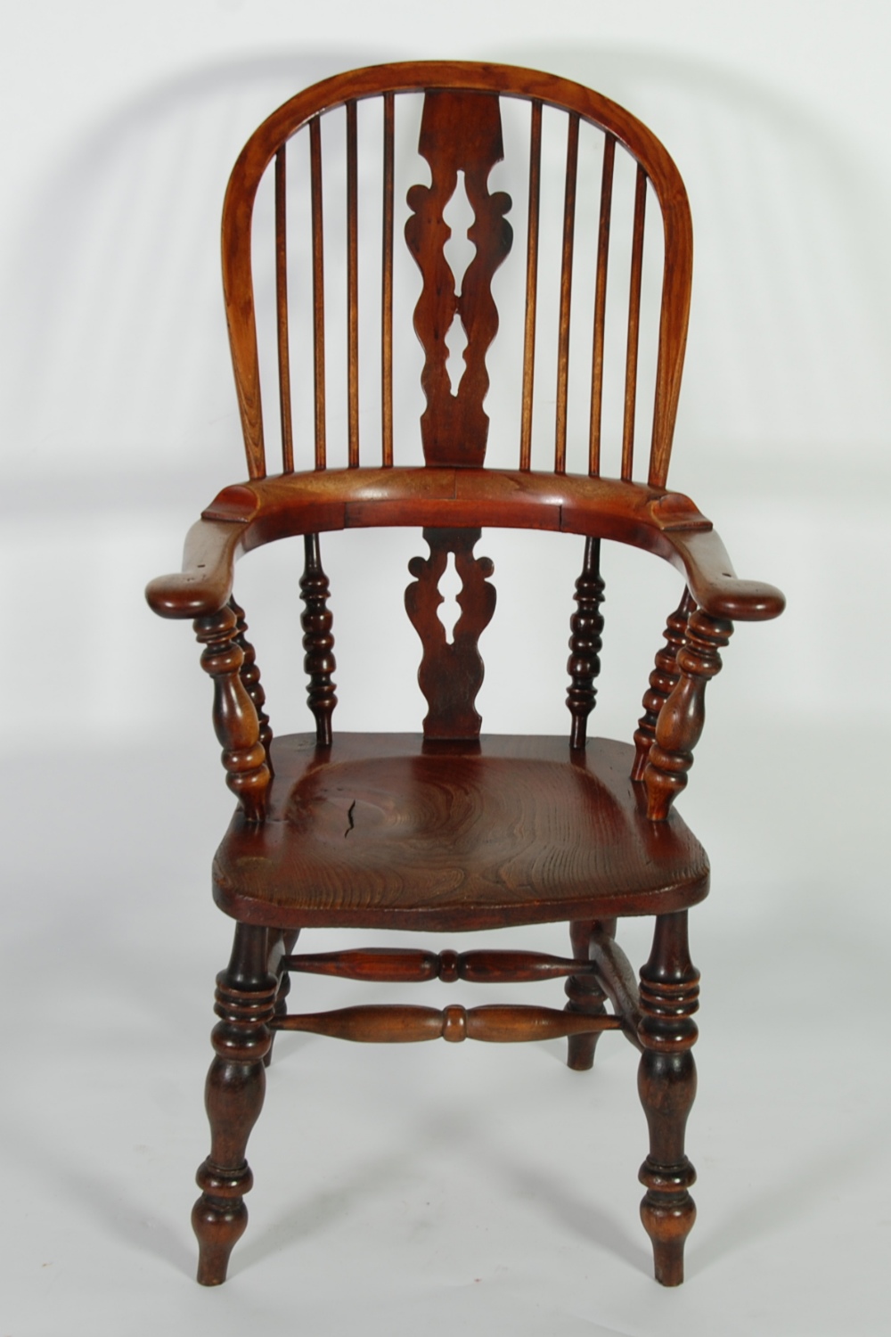 NINETEENTH CENTURY ELM, BEECHWOOD AND FRUITWOOD HIGH BACK WINDSOR CHAIR, the turned legs joined by