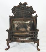 VICTORIAN CAST IRON AND STEEL FIREGRATE, the scroll cast back above a serpentine fronted basket,