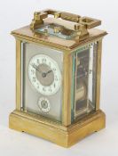 GILT BRASS REPEATING AND ALARM CARRIAGE CLOCK, circa 1900, the silvered mask with enamelled chapter