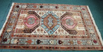 EASTERN RUG, with multi coloured octagonal triple chain medallions on a complicated pattered and