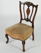 EDWARDIAN CARVED MAHOGANY AND MARQUETRY INLAID NURSING CHAIR, the pierced back with musical