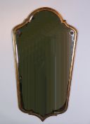 TWENTIETH CENTURY GILTWOOD WALL MIRROR, the bevel edged tapering plate with arch top and shaped