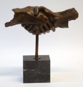 MODERN PATINATED BRONZE SHAKING HAND SCULPTURE, on black veined marble oblong base, 14 1/2"" (36.