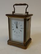 A 20TH CENTURY SWISS MADE BRASS TIME PIECE CARRIAGE CLOCK, the white enamel dial with retailer`s