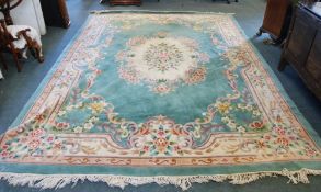 A CHINESE CARPET OF AUBUSSON DESIGN, with large off white and floral oval medallion and border,