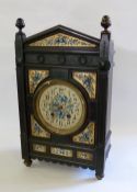 LATE VICTORIAN AESTHETIC MOVEMENT MANTEL CLOCK, the ebonised case carved with plumed corner pillars