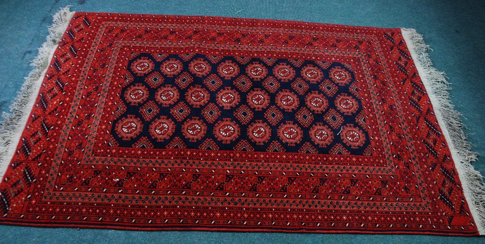 PAKISTAN SARIQ MAURI RUG, the midnight blue field decorated with three rows of guls and secondary