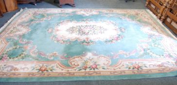 A WASHED CHINESE CARPET OF EMBOSSED AUBUSSON DESIGN, with green ground, off white and natural