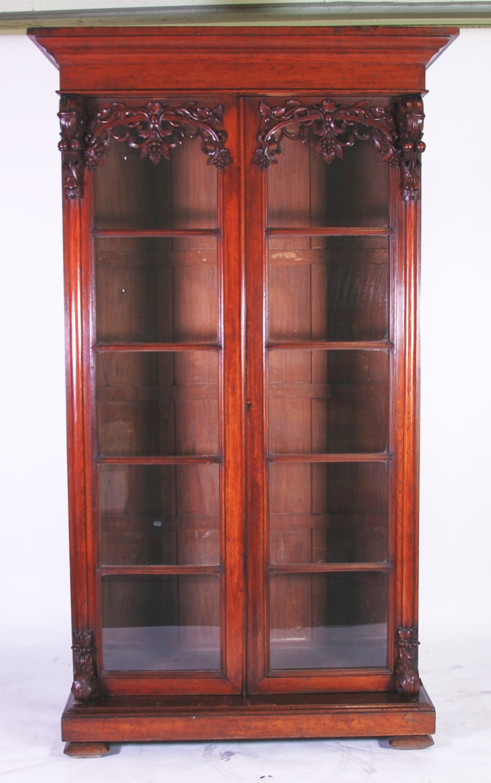 LATE 19th CENTURY CONTINENTAL CARVED WALNUT TWO DOOR LARGE BOOKCASE, the moulded cornice above a