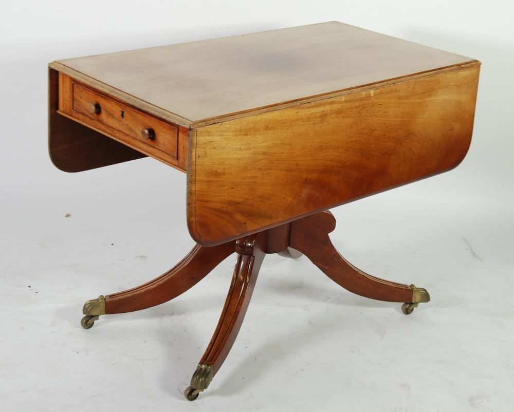 EARLY NINETEENTH CENTURY MAHOGANY PEDESTAL PEMBROKE TABLE, the moulded rounded oblong drop leaf top