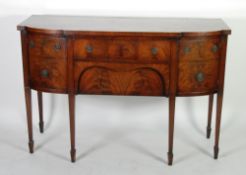 EARLY TWENTIETH CENTURY SHERATON STYLE FIGURED MAHOGANY SIDEBOARD, the stepped bow fronted