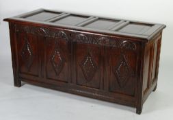 17th CENTURY CARVED OAK COFFER, the four panel, hinged top above a conforming front with lunette