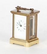 EARLY TWENTIETH CENTURY MINIATURE GILT BRASS CARRIAGE CLOCK, typical form with white roman dial and