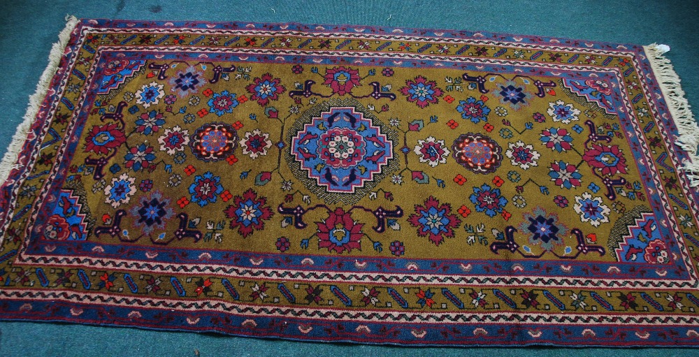 LARGE EASTERN RUG, with pale blue and centre medallion with stepped edge and matching spandrels, on