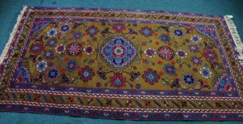 LARGE EASTERN RUG, with pale blue and centre medallion with stepped edge and matching spandrels, on