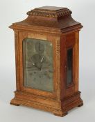 EARLY TWENTIETH CENTURY CARVED OAK MANTEL CLOCK by Gustav Becker, the silvered roman dial with