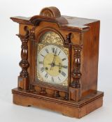 EARLY TWENTIETH CENTURY WALNUTWOOD MANTEL CLOCK, the arched dial with silvered roman chapter ring,