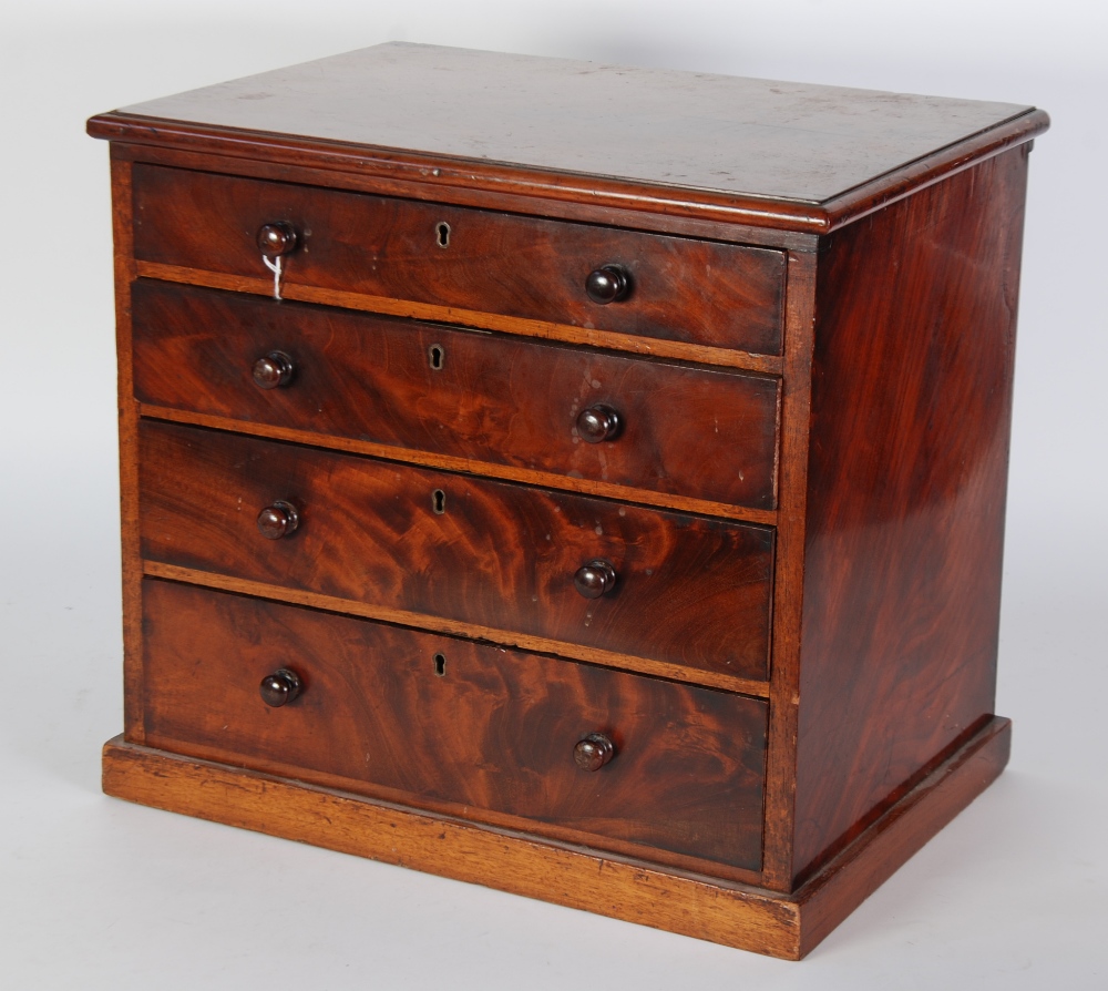 NINETEENTH CENTURY FIGURED MAHOGANY TABLE TOP CHEST OF FOUR GRADUATED LONG DRAWERS, with mahogany