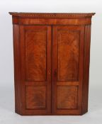 EARLY NINETEENTH CENTURY FLAME CUT MAHOGANY AND LINE INLAID CORNER CUPBOARD, the moulded cornice