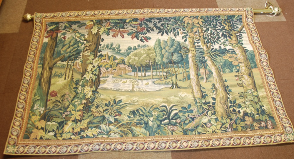A MODERN MACHINE WOVEN PICTORIAL TAPESTRY, ""The Hamlet"", suspended from a brass pole with wall