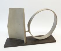 AUSTIN WRIGHT (1911-1997) ABSTRACT SCULPTURE IN STEEL Circular and angled panel on a black wood