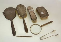 A SILVER BACKED ART DECO DRESSING TABLE SET, comprising hand mirror, long handled hairbrush and