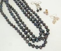 A THREE STRAND NECKLACE OF GREY CULTURED PEARLS, with metal clasp AND THREE PAIRS OF CULTURED